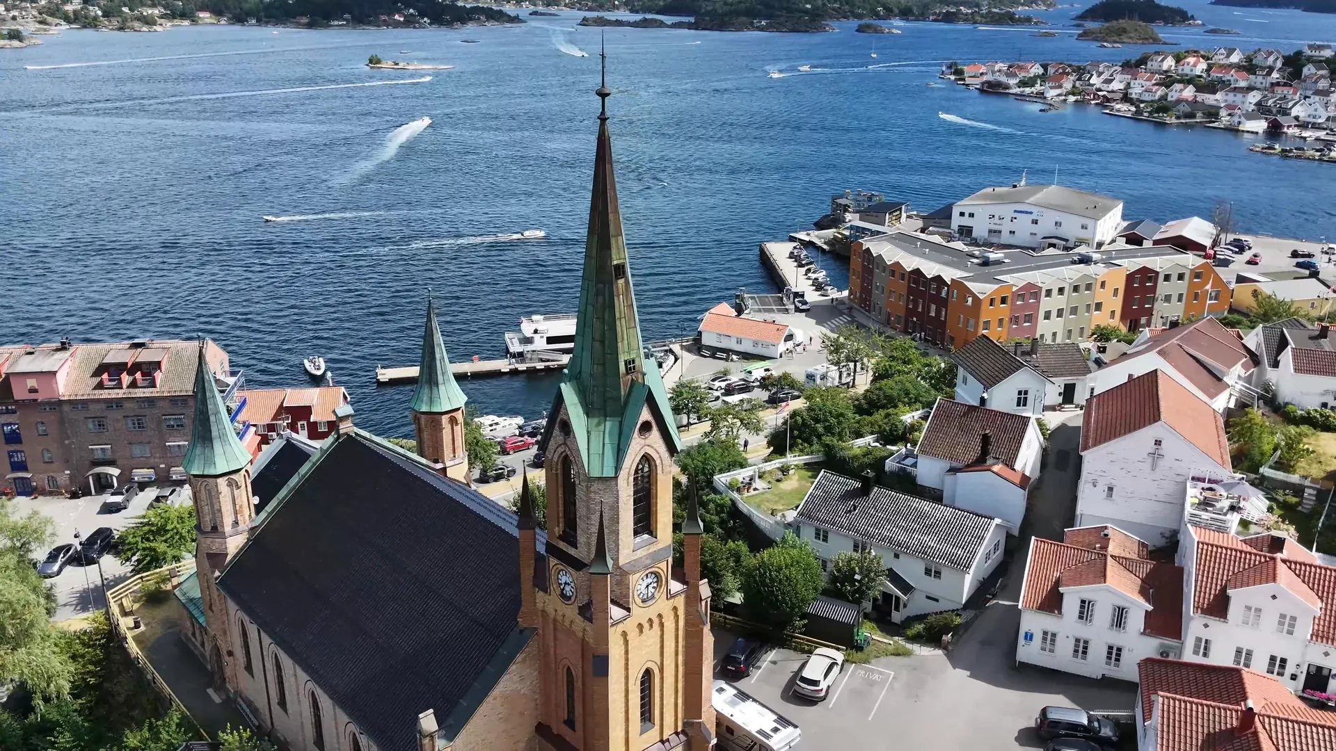 Kragerø Church spire seen from the drone, with the harbour behind it